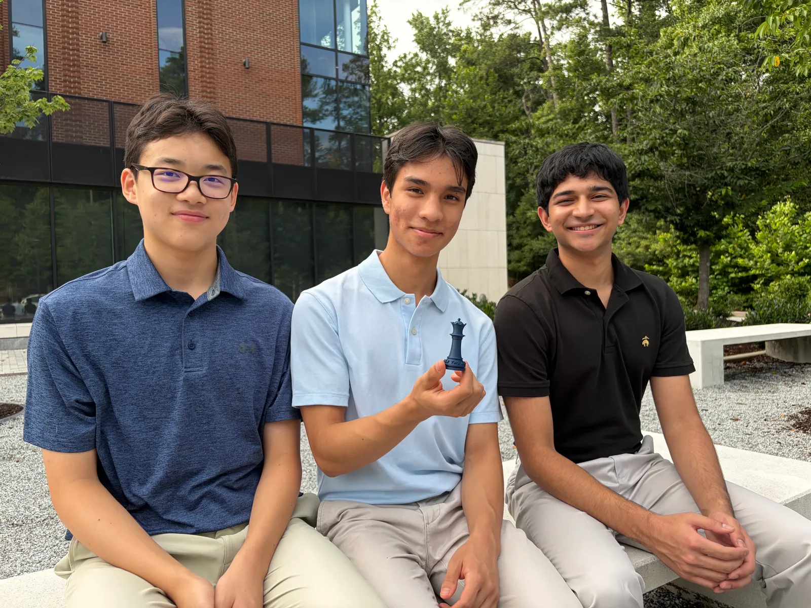 Rule the Board's three founders, Nathan Ye, Leonardo Castro-Balbi, and Arjun Garg, sitting together outdoors.