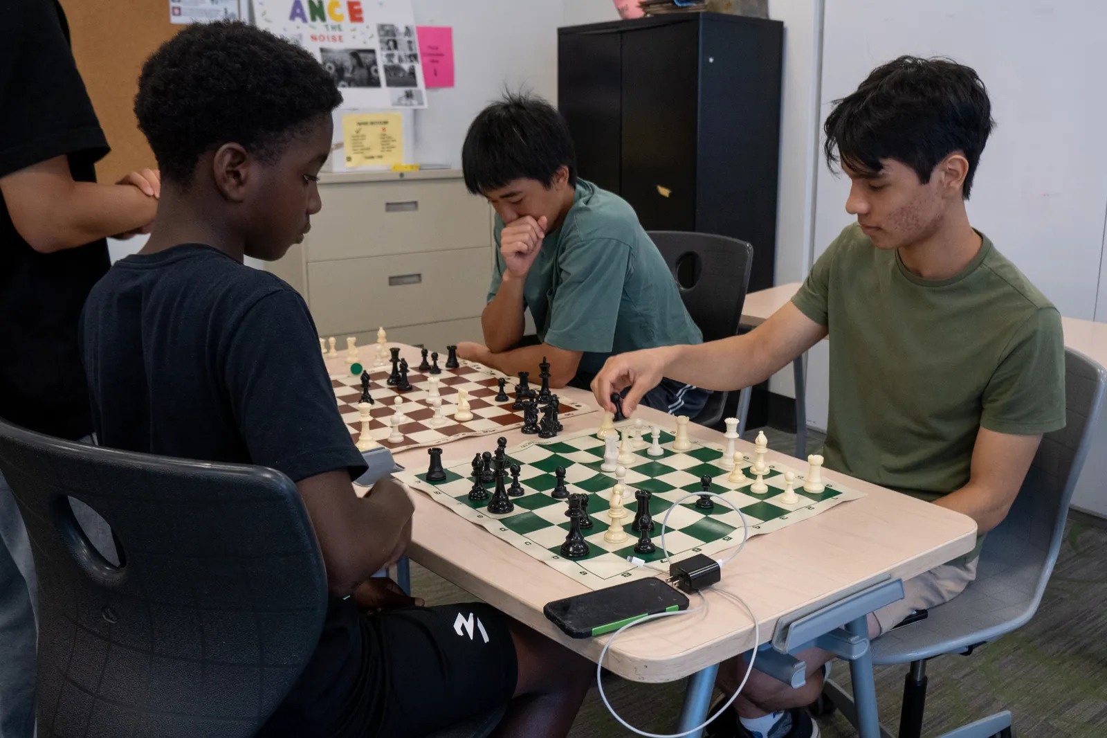 Students playing over-the-board games during a Checkmate Your Summer session.