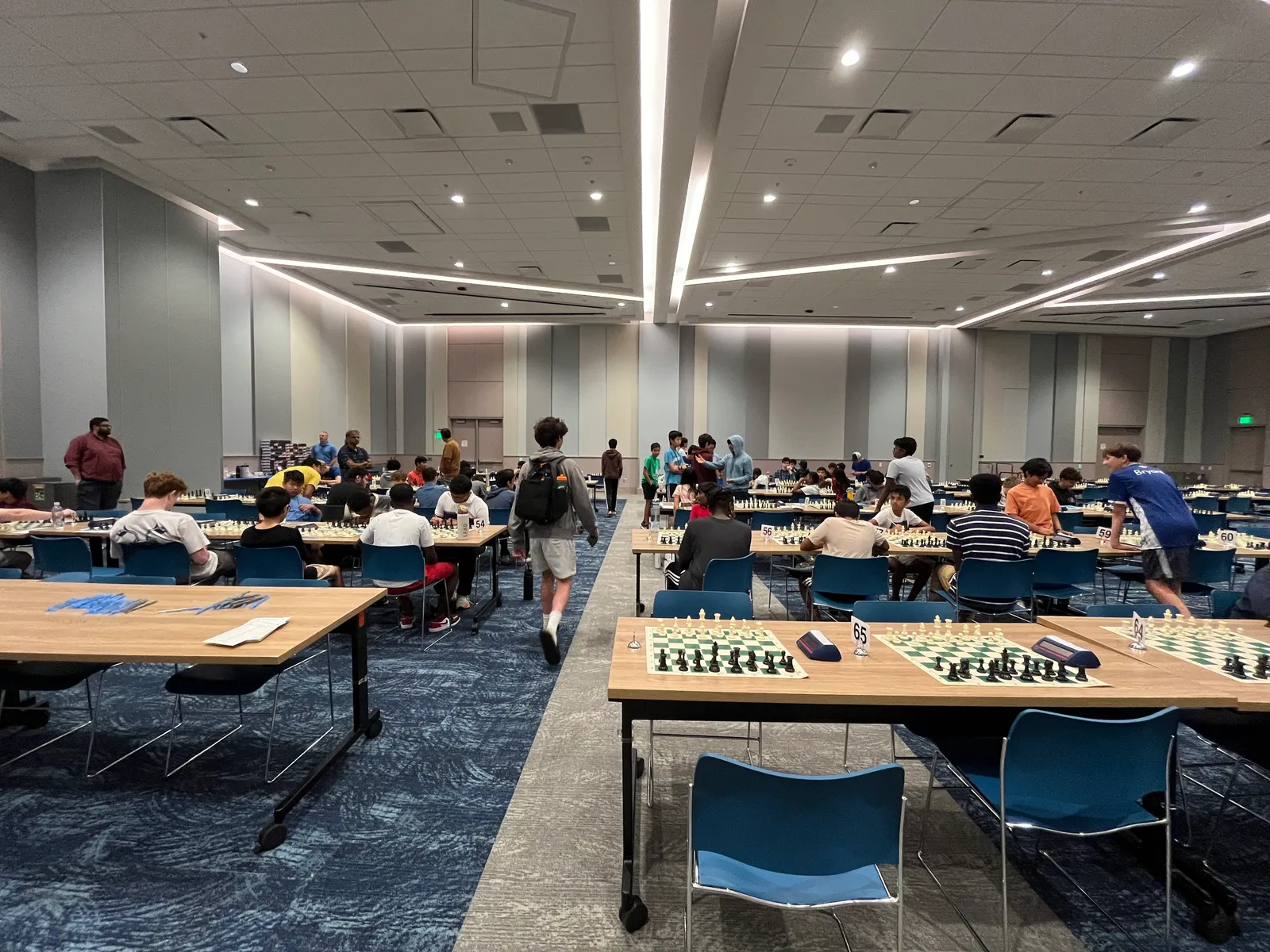 Scholars competing at the Emory Castle Chess Grand Prix, a tournament hall filled with chess boards.